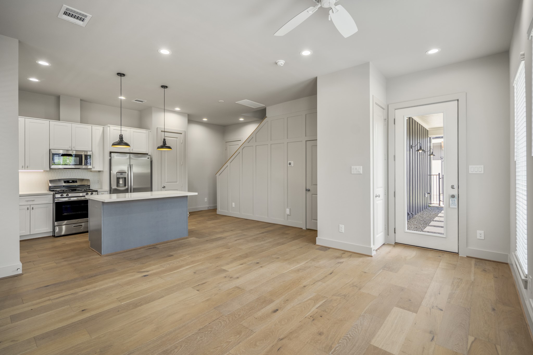 5229 Hillman Street, Unit A Houston, TX 77023 - Photo 4 of 50 an open kitchen with a refrigerator and a stove top oven