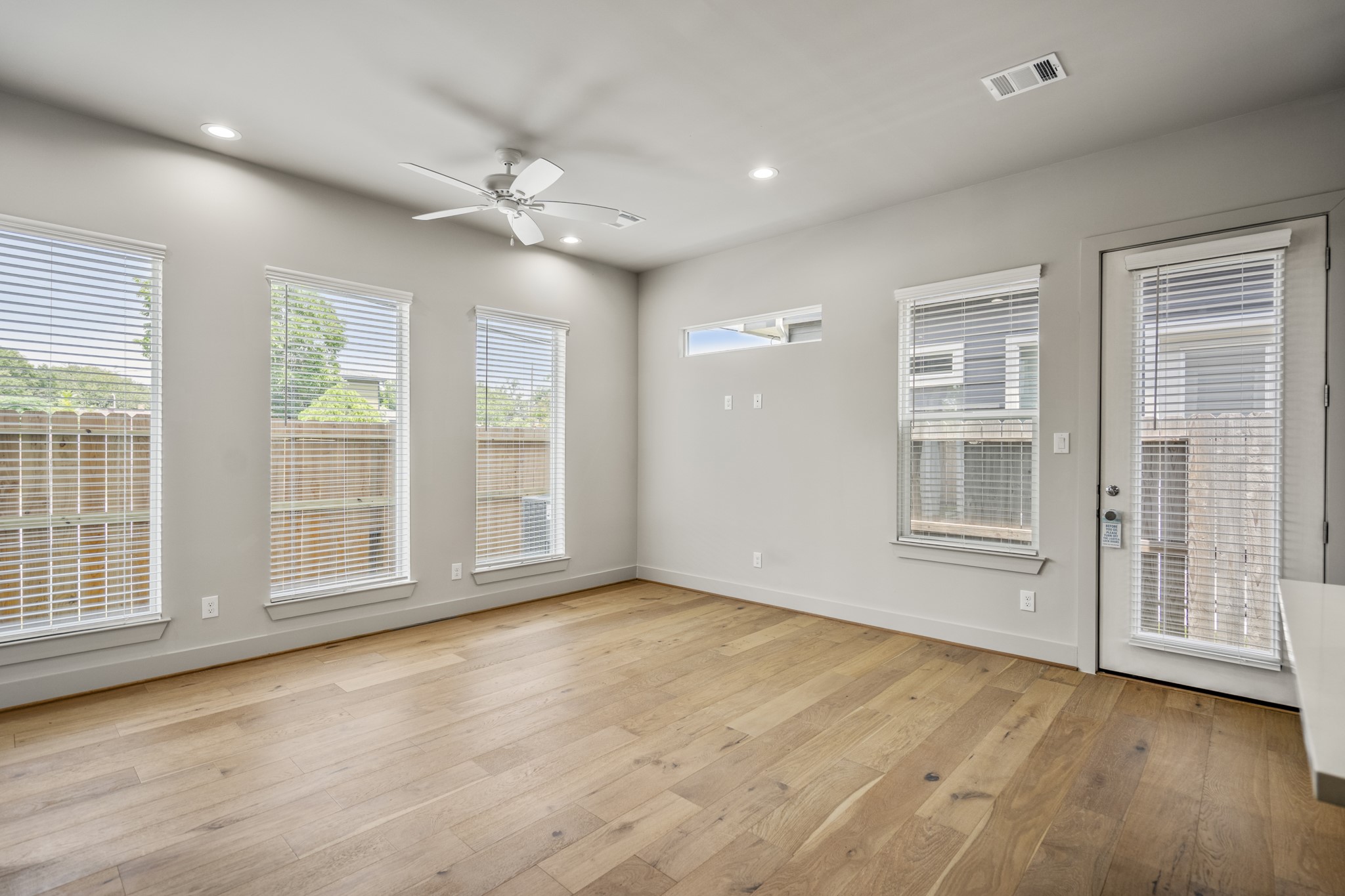 5229 Hillman Street, Unit A Houston, TX 77023 - Photo 9 of 50 a view of an empty room with a window and wooden floor