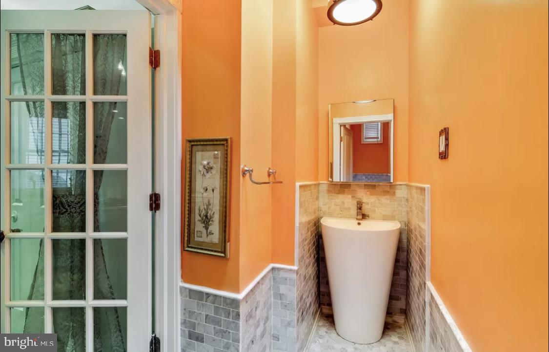 26 Strawberry Street Philadelphia, PA 19106 - Photo 11 of 64 a bathroom with a sink a mirror and shower