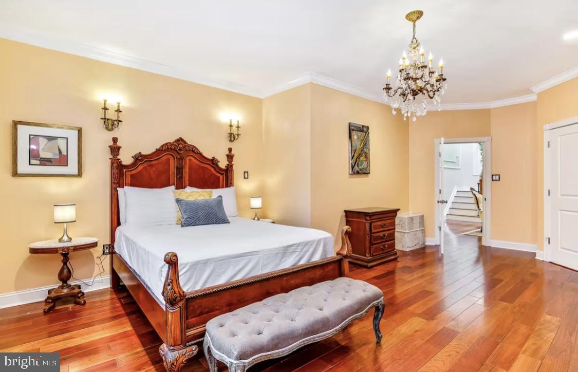 26 Strawberry Street Philadelphia, PA 19106 - Photo 17 of 64 a bedroom with a bed and a chandelier