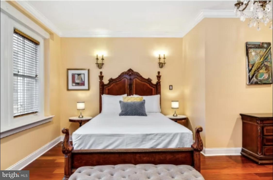 26 Strawberry Street Philadelphia, PA 19106 - Photo 18 of 64 a bedroom with a bed and wooden floor