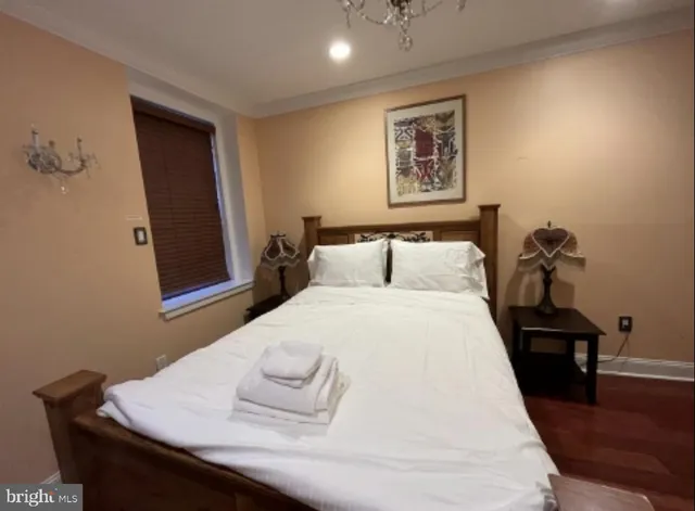 a bedroom with a bed and a chandelier