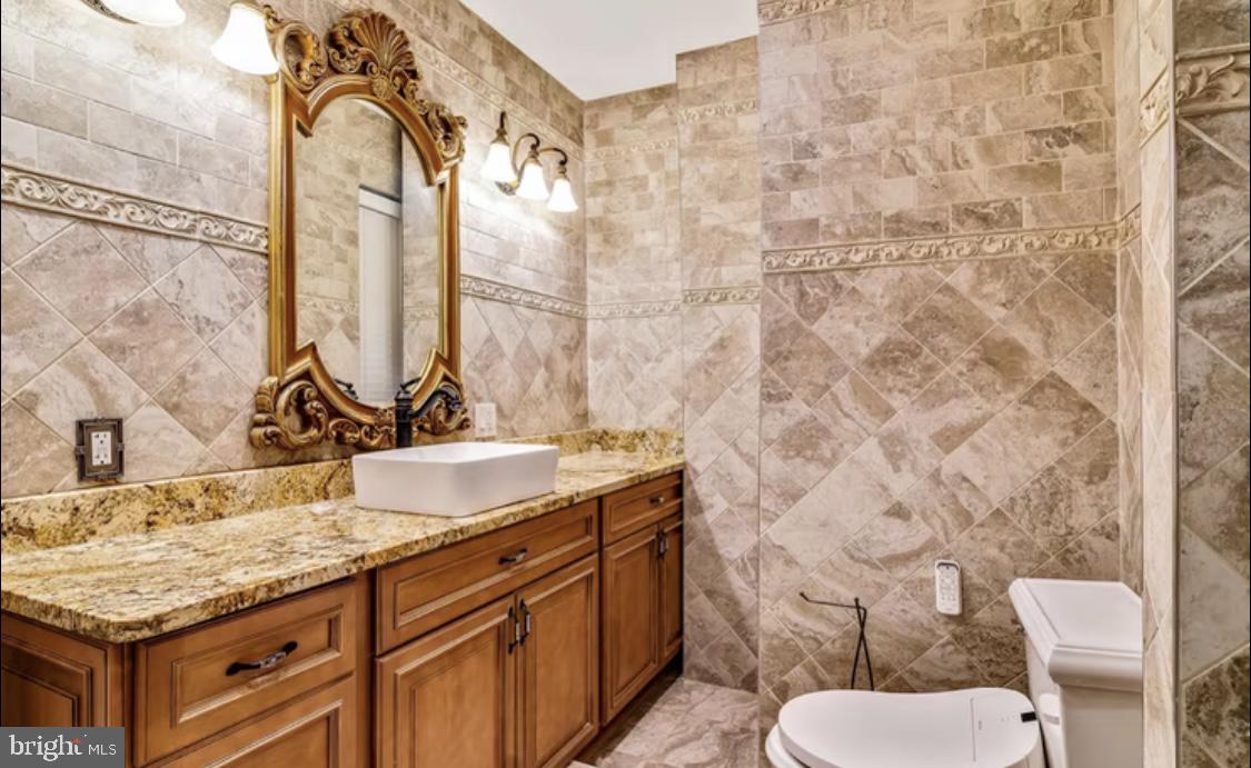 26 Strawberry Street Philadelphia, PA 19106 - Photo 22 of 64 a bathroom with a granite countertop sink a toilet and a mirror
