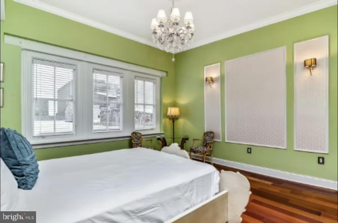 26 Strawberry Street Philadelphia, PA 19106 - Photo 26 of 64 a bedroom with a bed and a chandelier