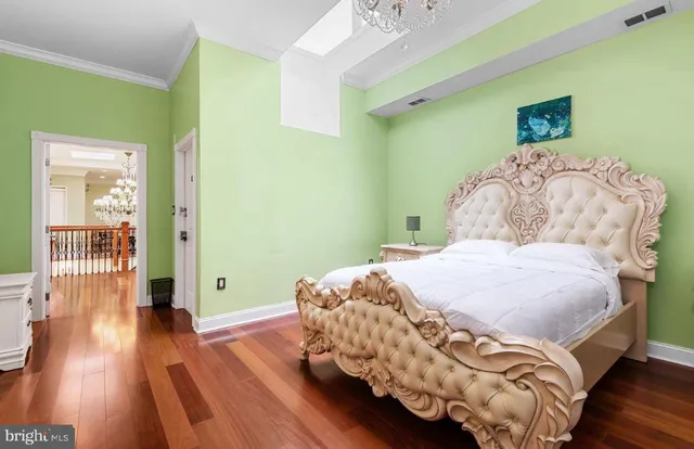 a bedroom with a bed table and a chair