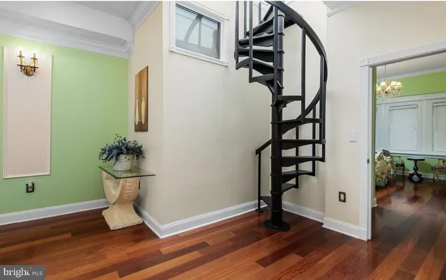 a living room with furniture a flat screen tv and kitchen view