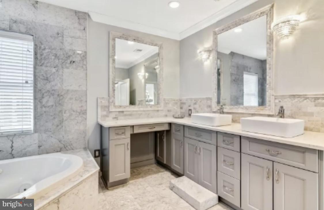 26 Strawberry Street Philadelphia, PA 19106 - Photo 30 of 64 a bathroom with a sink double vanity mirror and a bathtub