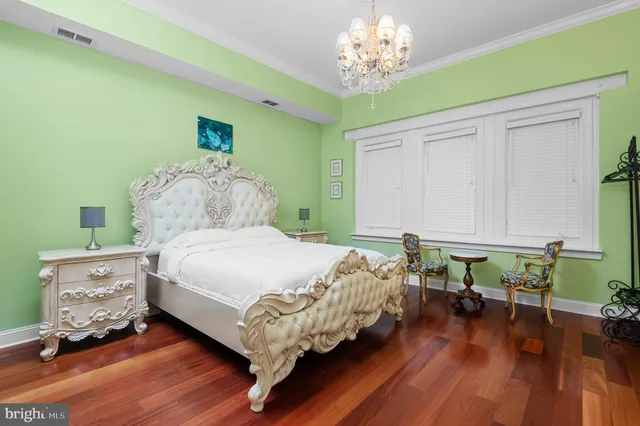 a bedroom with a bed dresser and window