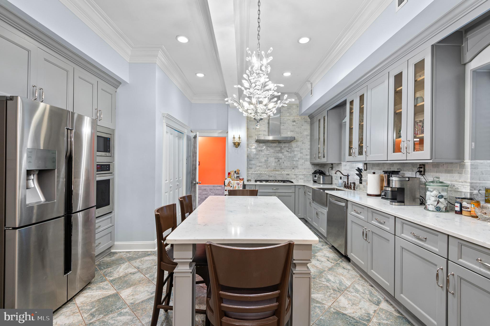 26 Strawberry Street Philadelphia, PA 19106 - Photo 37 of 64 a kitchen with stainless steel appliances a dining table chairs stove and refrigerator