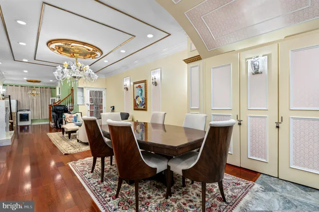 a view of a dining room with furniture wooden floor and chandelier