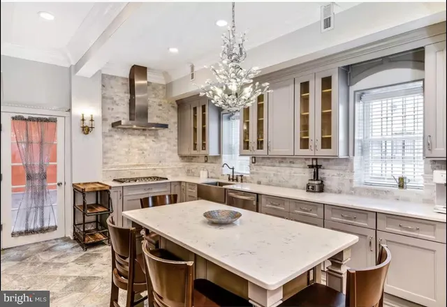 a view of a dining room with furniture and a chandelier