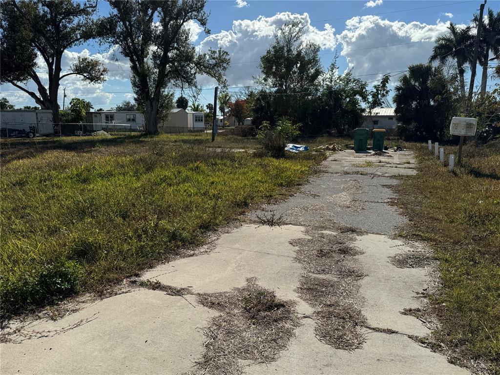 3840 Bravo Road Port Charlotte, FL 33953 - Photo 1 of 1 a view of dirt yard with a large tree
