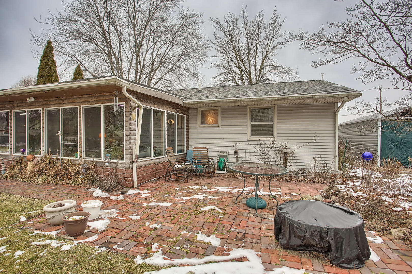 408 Kyle Street Ogden, IL 61859 - Photo 23 of 24 a view of a backyard with table and chairs and potted plants