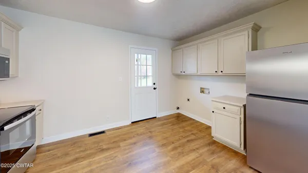 a view of a kitchen with wooden floor