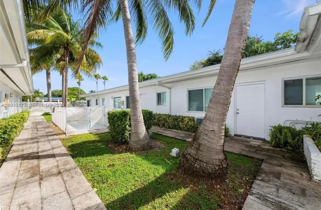 a front view of a house with a garden and plants