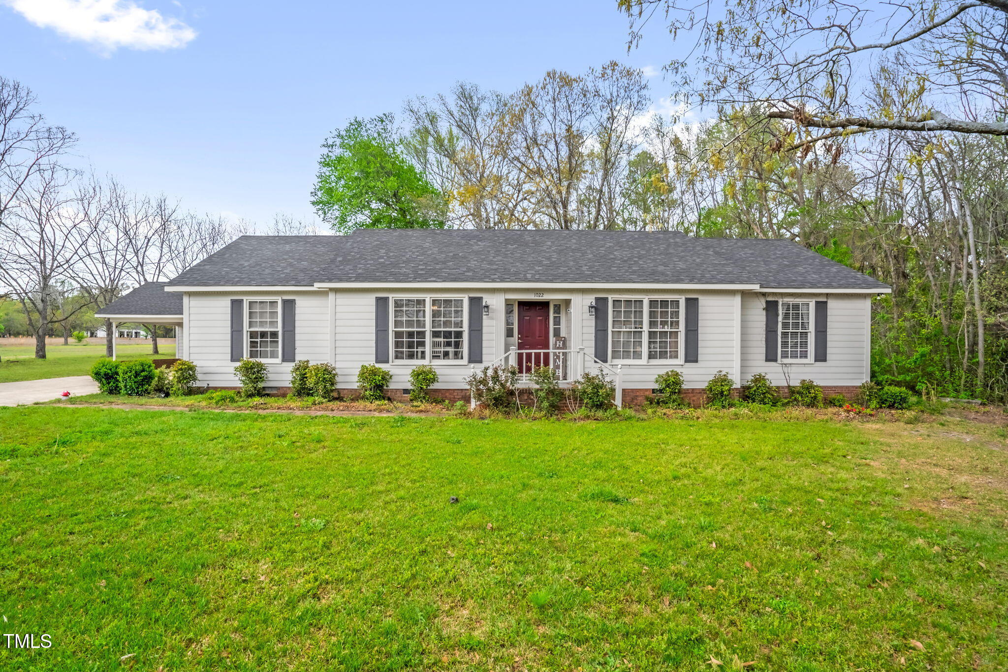 1022 Glover Road Dunn, NC 28334 - Photo 1 of 31 a front view of a house with a yard and trees