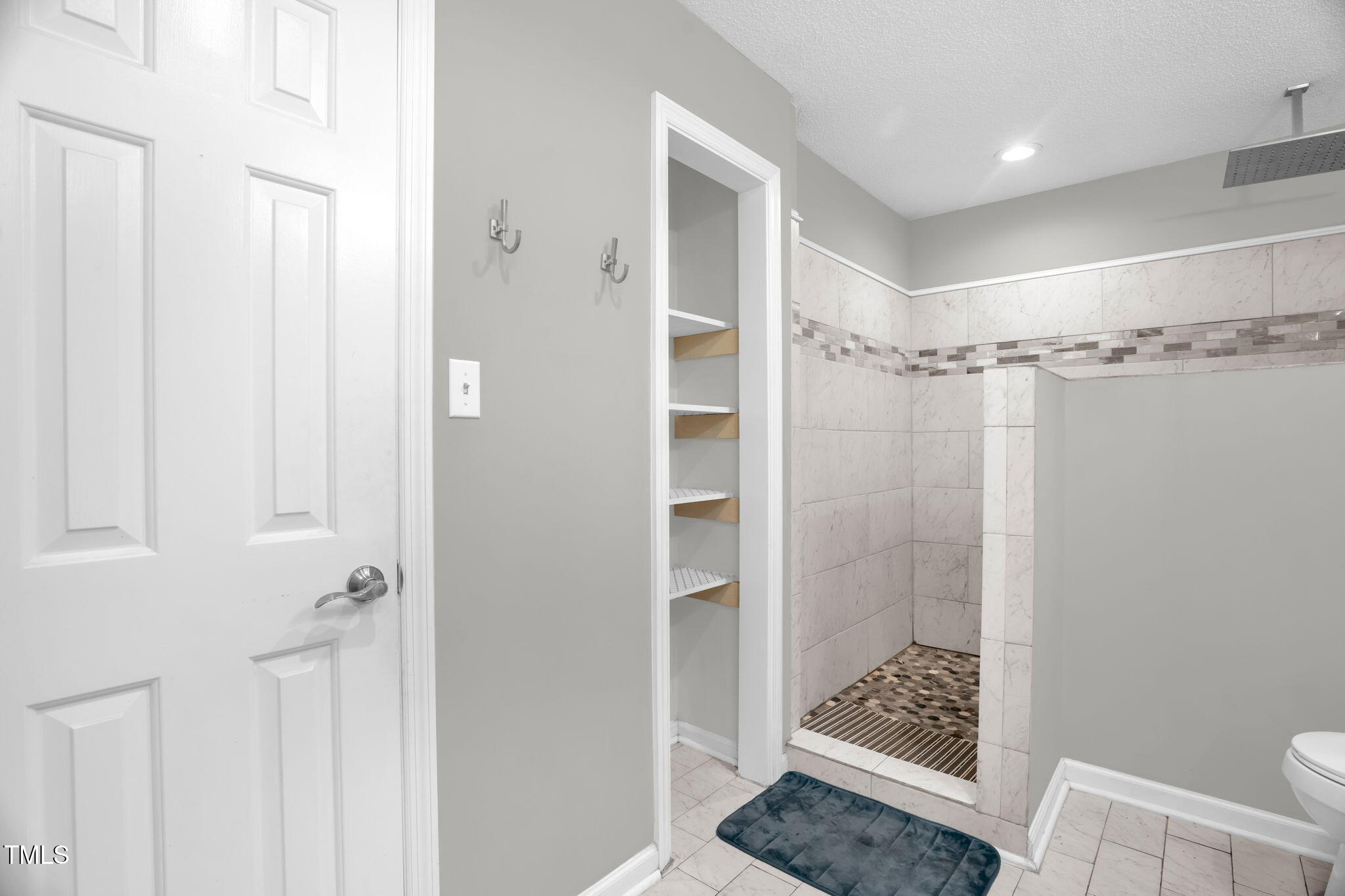 1022 Glover Road Dunn, NC 28334 - Photo 20 of 31 a bathroom with a glass shower door