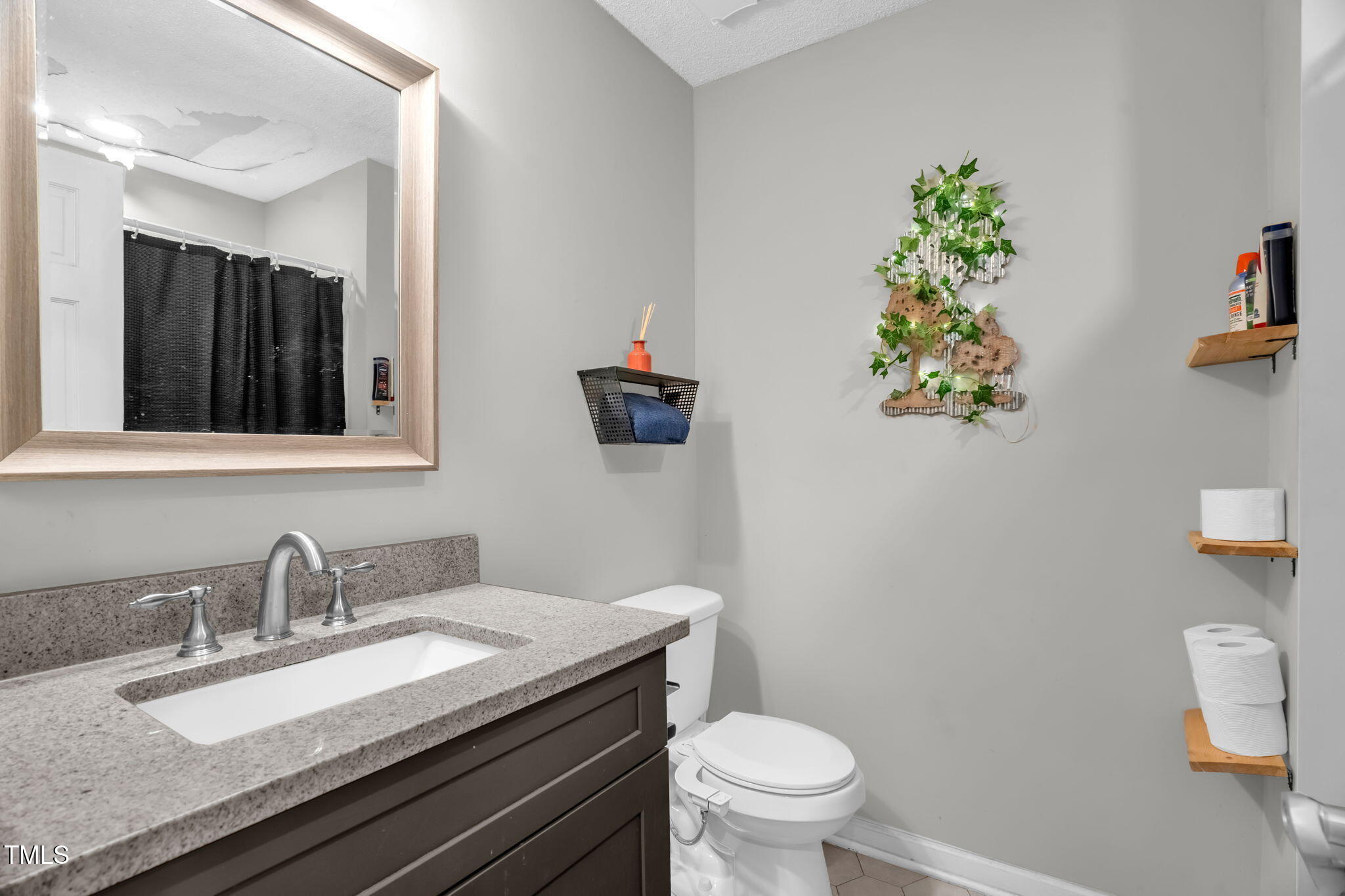 1022 Glover Road Dunn, NC 28334 - Photo 23 of 31 a bathroom with a granite countertop toilet sink and mirror