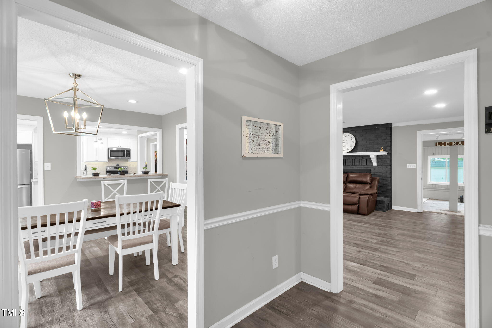 1022 Glover Road Dunn, NC 28334 - Photo 6 of 31 a kitchen with a dining table chairs and wooden floor