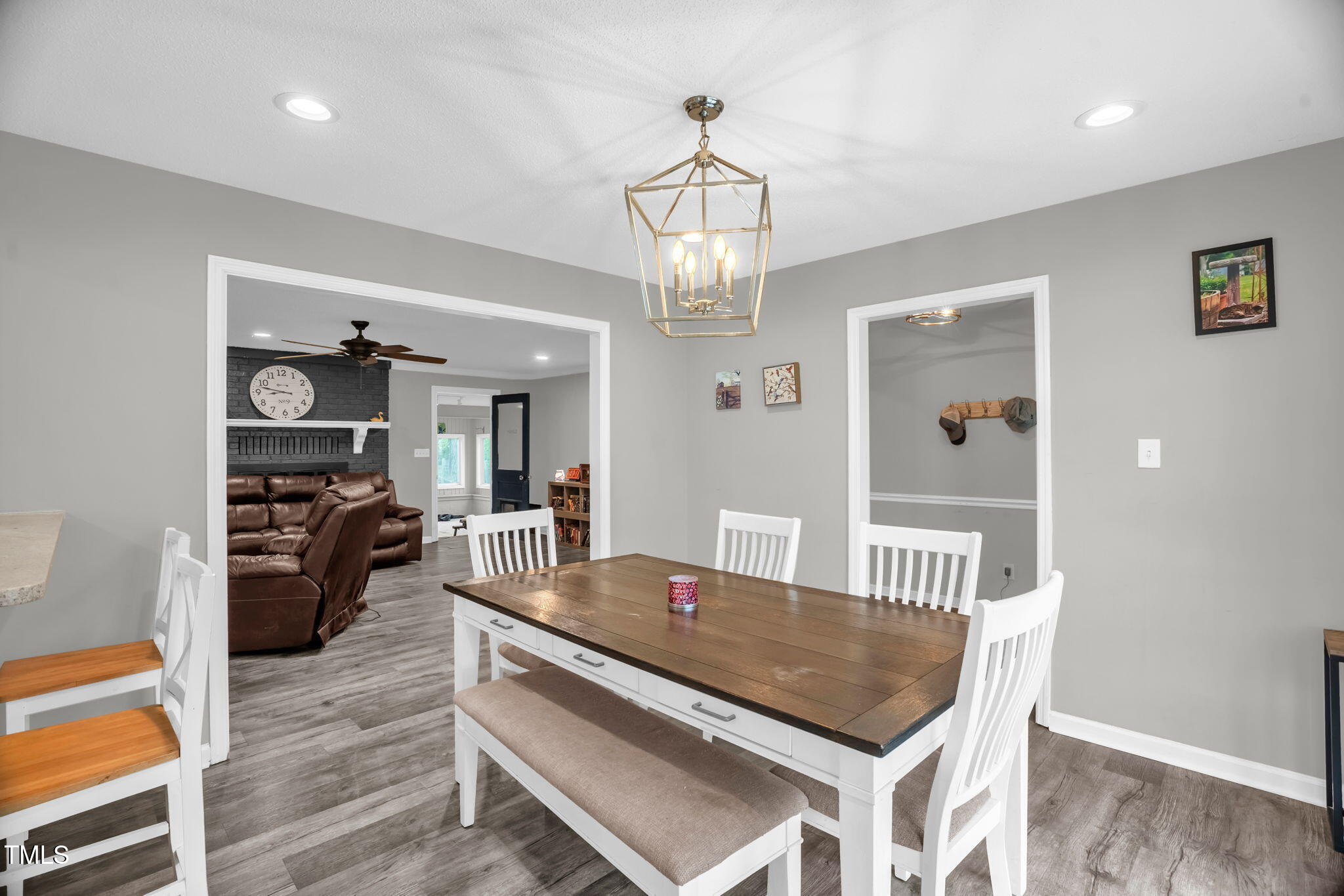 1022 Glover Road Dunn, NC 28334 - Photo 8 of 31 a view of a dining room with furniture a chandelier and wooden floor