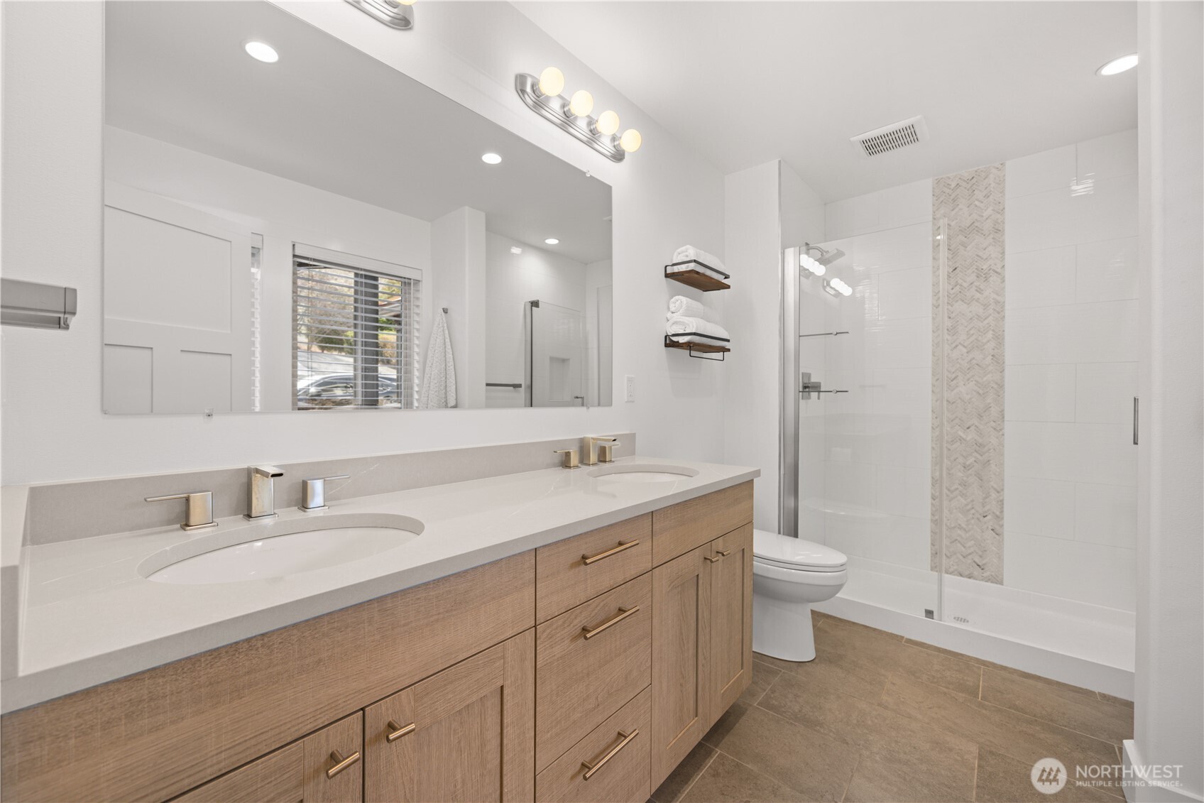21 Grace Lane Chelan, WA 98816 - Photo 15 of 37 a bathroom with a double vanity sink a toilet and a mirror