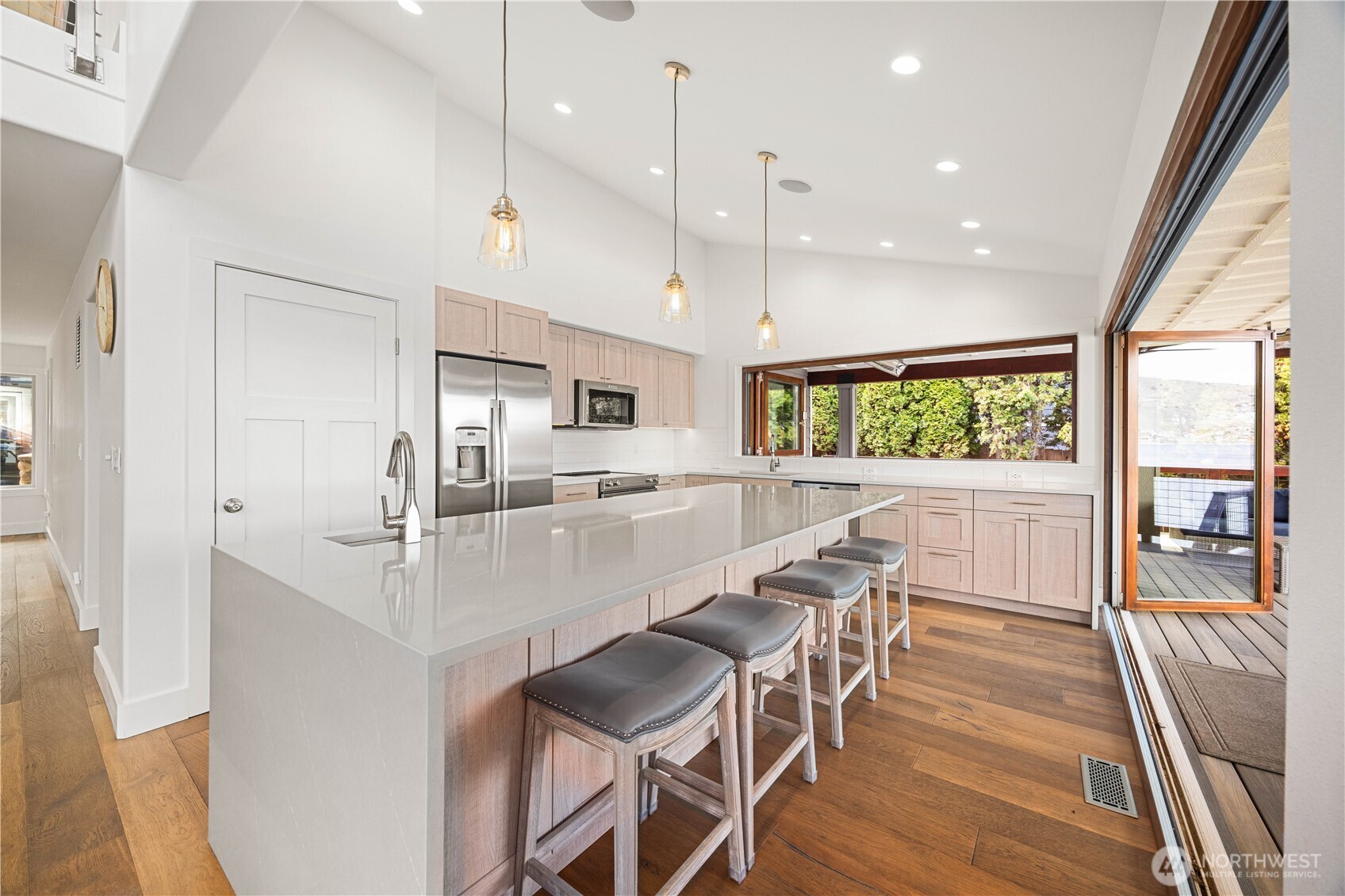 21 Grace Lane Chelan, WA 98816 - Photo 10 of 37 a kitchen with stainless steel appliances a dining table chairs sink and wooden floor