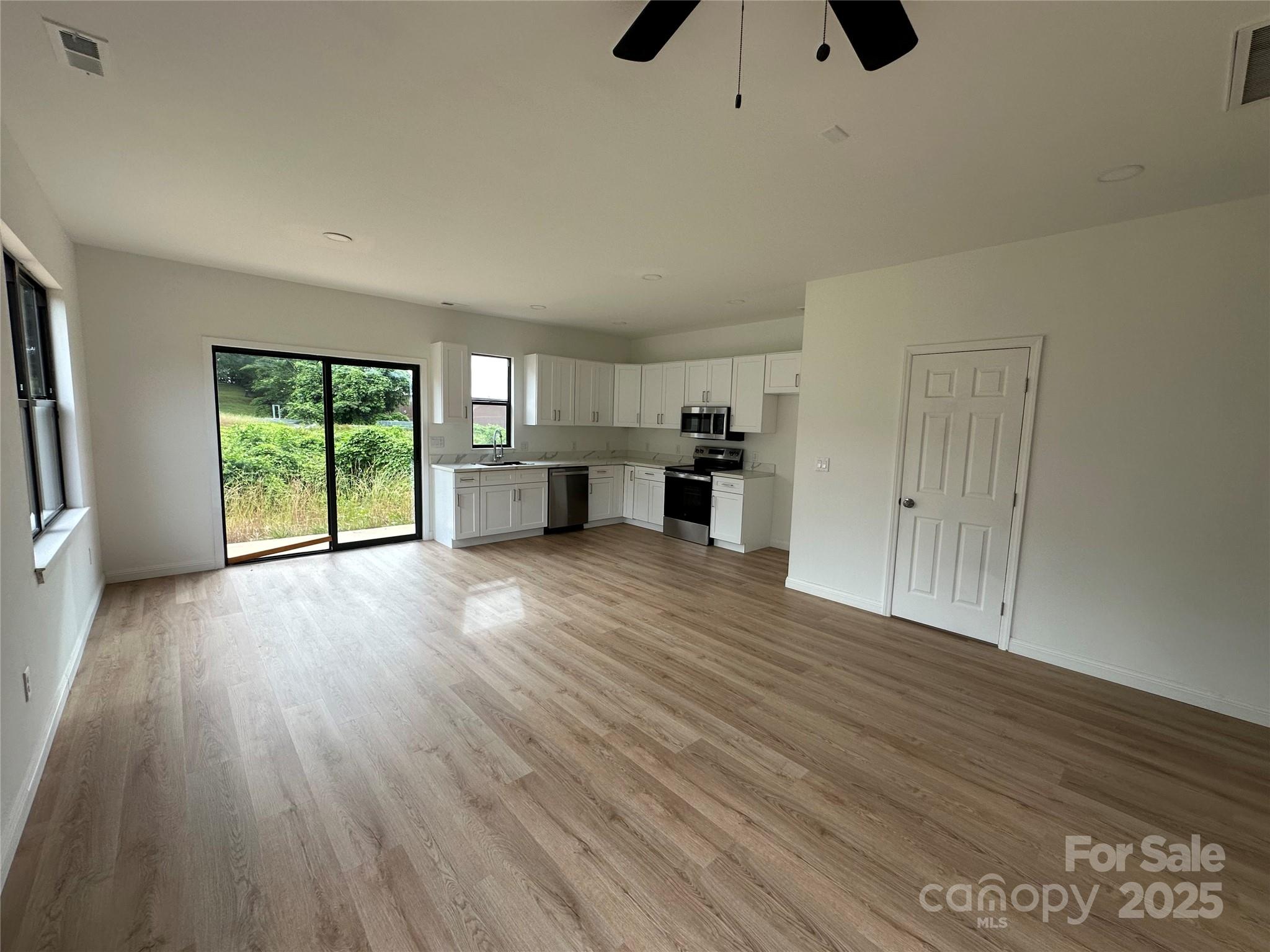 804 3rd St Place Southwest Hickory, NC 28602 - Photo 2 of 10 wooden floor in an empty room with a window