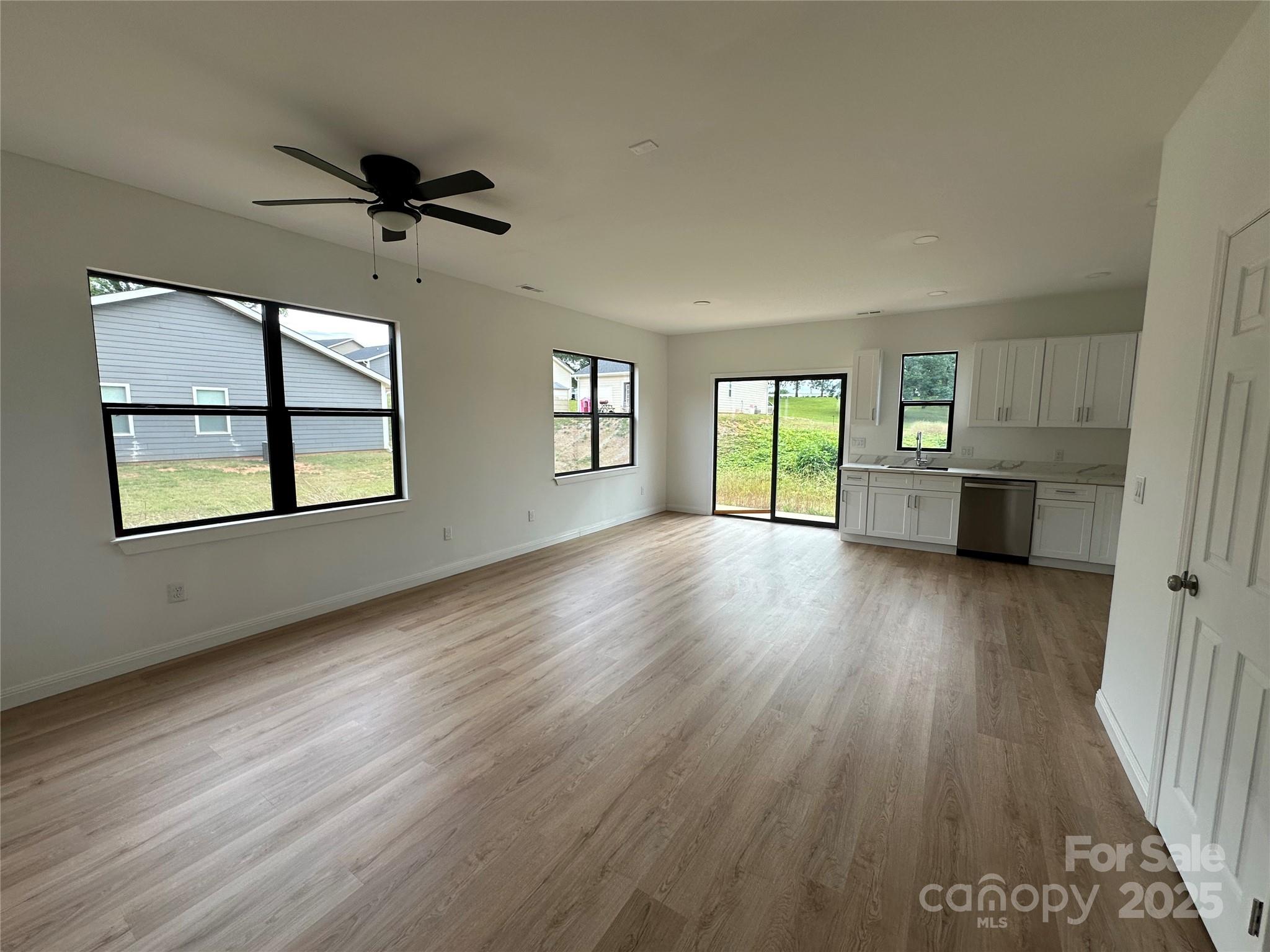 804 3rd St Place Southwest Hickory, NC 28602 - Photo 3 of 10 wooden floor in an empty room with a window
