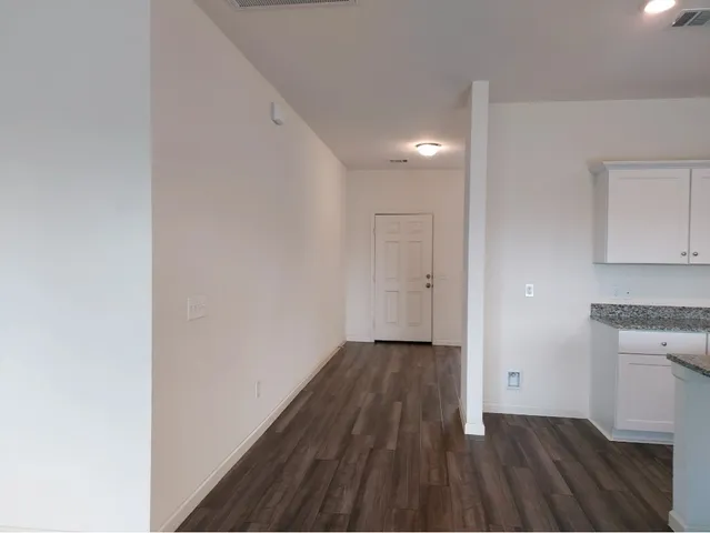 a view of a room with wooden floor and a sink