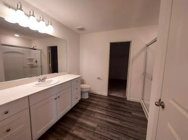 a bathroom with a double vanity sink and a mirror