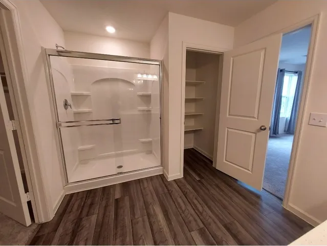 a bathroom with a glass door shower