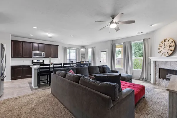 a living room with furniture kitchen and a fireplace