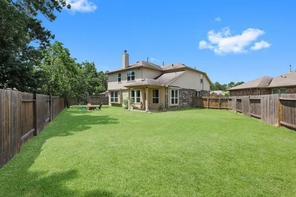 a front view of a house with yard and green space
