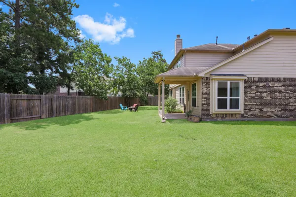 a view of a house with backyard sitting area and garden