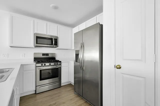 a kitchen with a refrigerator stove and microwave
