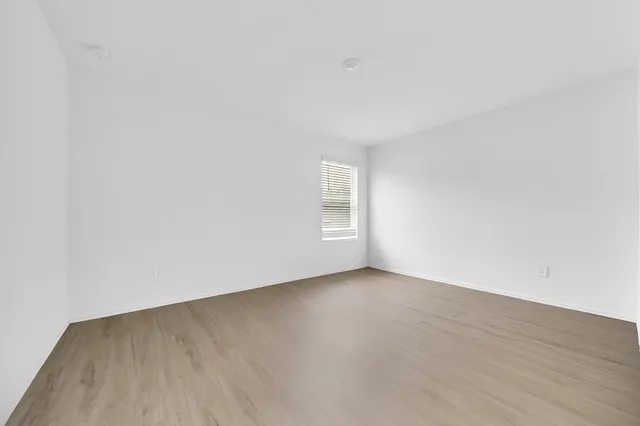 a view of an empty room and wooden floor