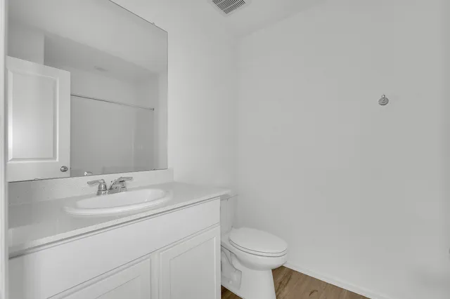 a bathroom with a sink a toilet and mirror