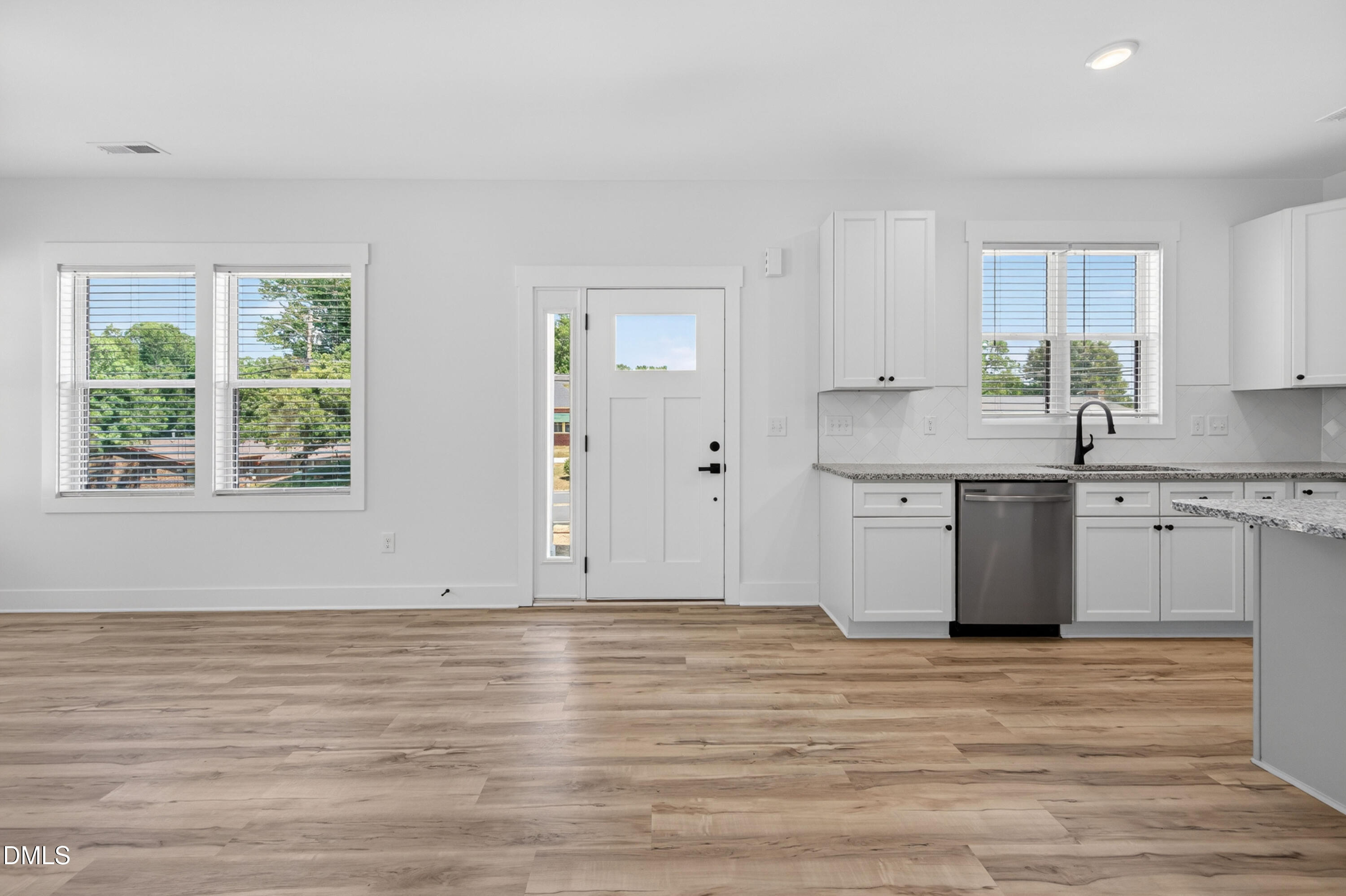 1182 Hurdle Mills Road Roxboro, NC 27573 - Photo 7 of 45 a view of a kitchen with wooden floor and electronic appliances