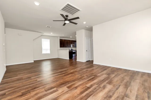 wooden floor in an empty room with a window