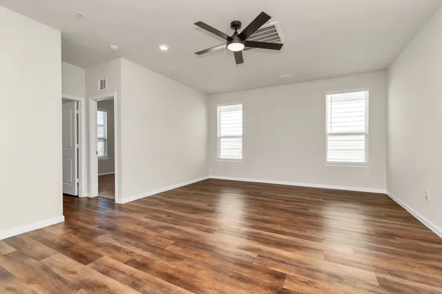 wooden floor in an empty room with a window