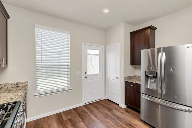 a kitchen with a refrigerator and a window