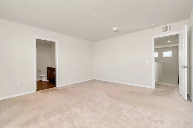 an empty room with an entryway and fireplace