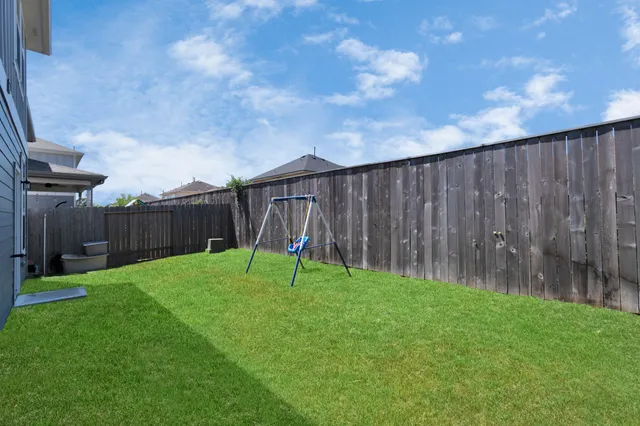 a view of backyard with wooden fences