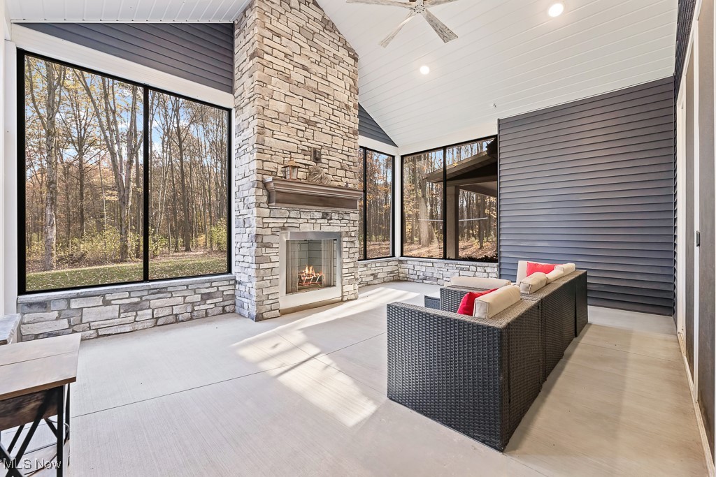 9340 Yale Road Diamond, OH 44412 - Photo 20 of 50 View of 3-seasons patio featuring an outdoor living space with a wood-burning (never used) fireplace and ceiling fan