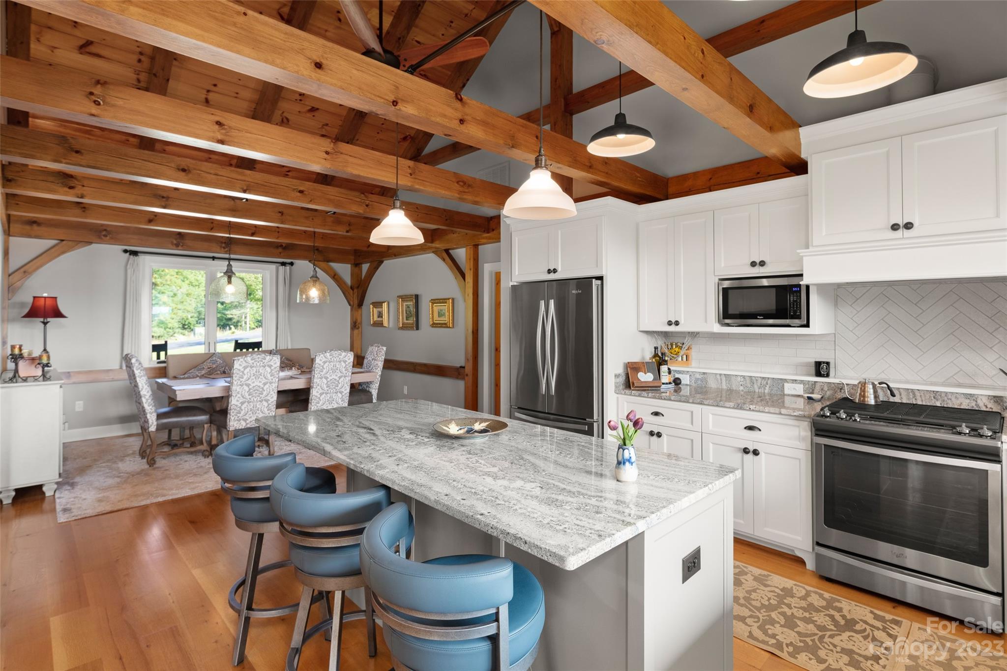 285 Red Tail Trail Mill Spring Mill Spring, NC 28756 - Photo 17 of 48 a kitchen with a table chairs stove and refrigerator
