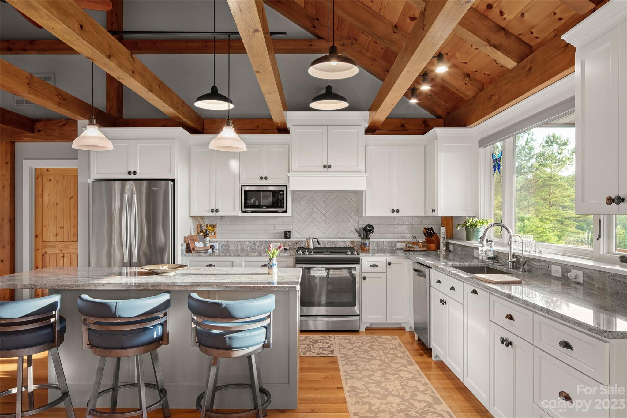 285 Red Tail Trail Mill Spring Mill Spring, NC 28756 - Photo 19 of 48 a kitchen with stainless steel appliances granite countertop a sink a stove and cabinets