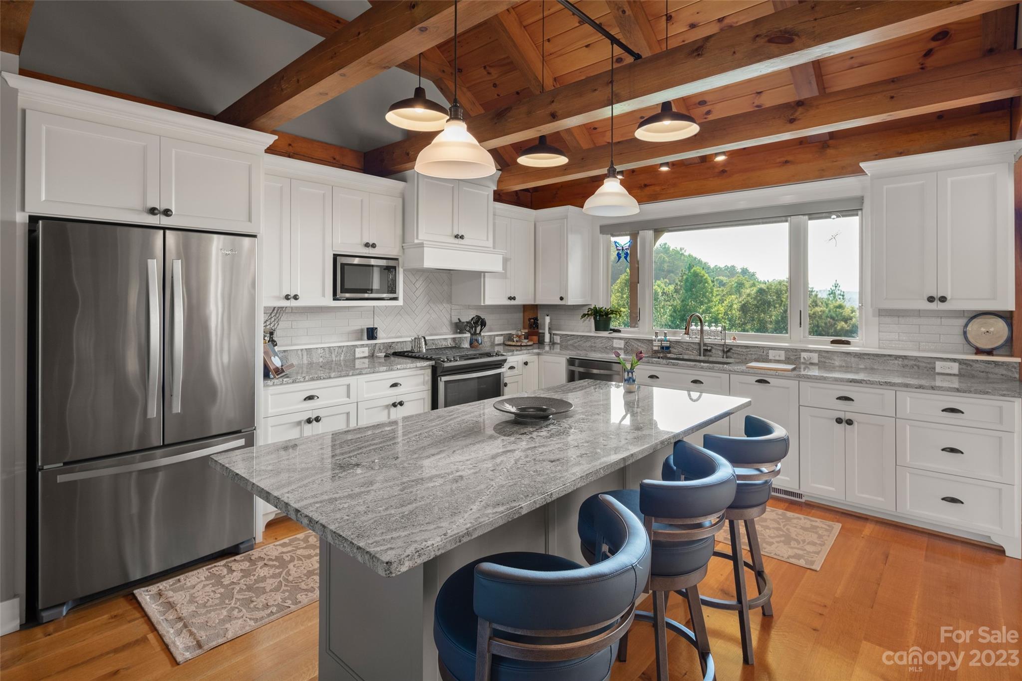 285 Red Tail Trail Mill Spring Mill Spring, NC 28756 - Photo 20 of 48 a kitchen with stainless steel appliances granite countertop a sink a stove a refrigerator cabinets and chairs
