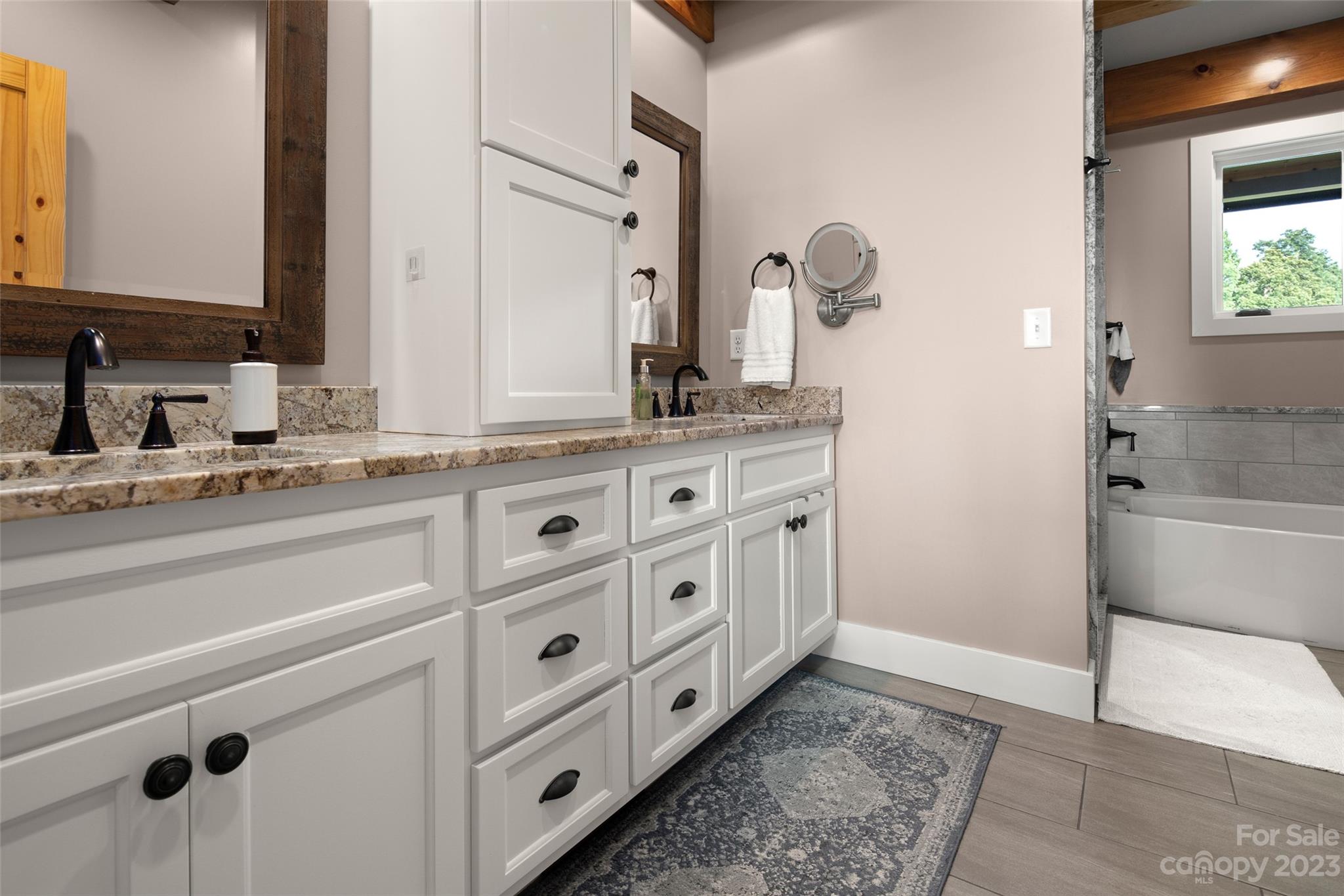 285 Red Tail Trail Mill Spring Mill Spring, NC 28756 - Photo 25 of 48 a bathroom with a granite countertop sink and a mirror