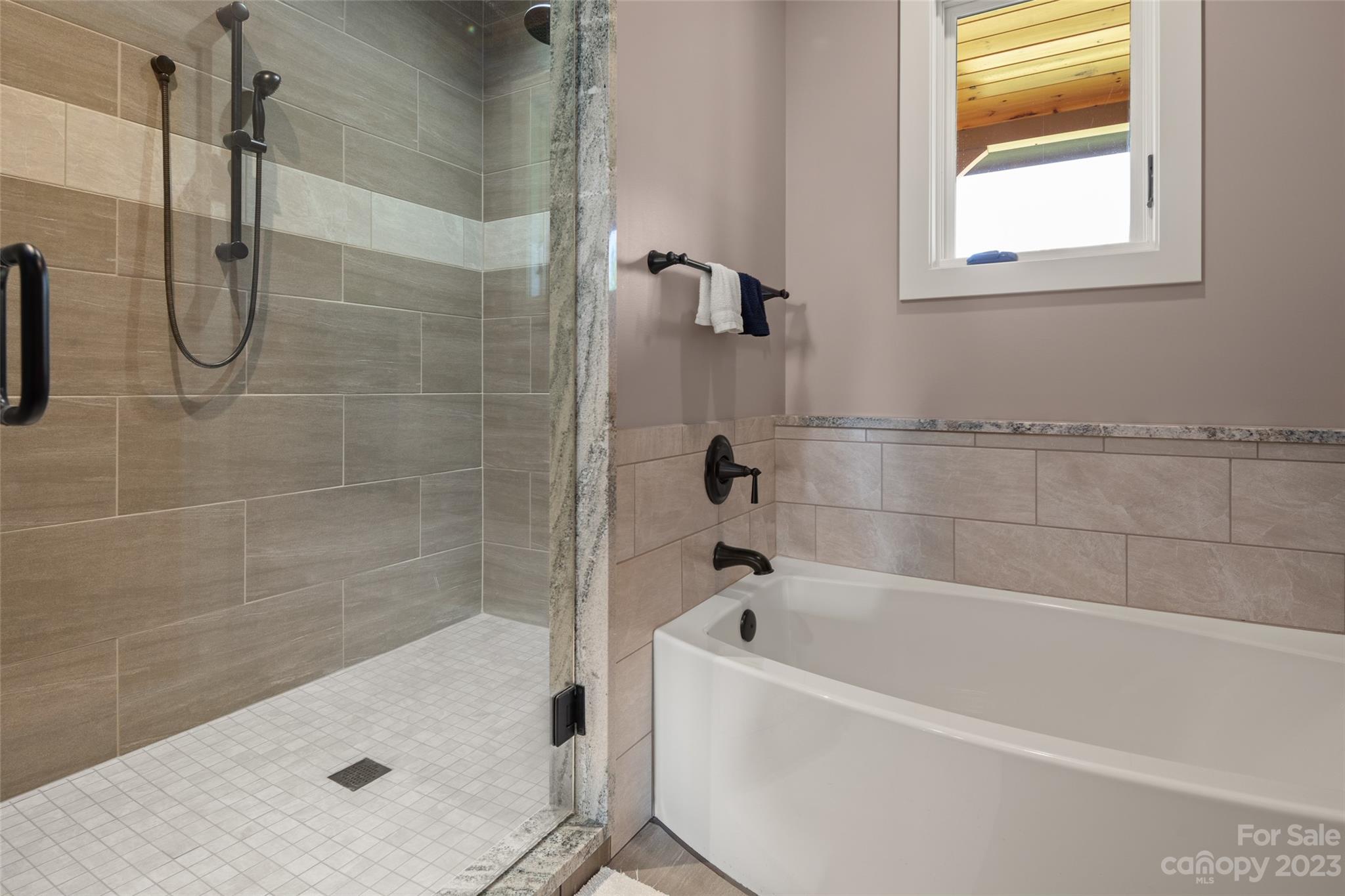 285 Red Tail Trail Mill Spring Mill Spring, NC 28756 - Photo 26 of 48 a bathroom with a bath tub with a shower