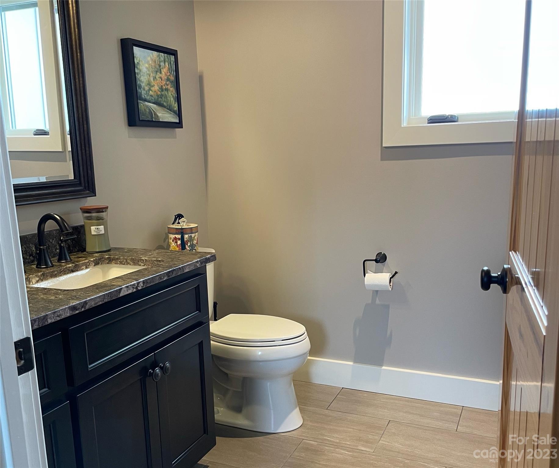 285 Red Tail Trail Mill Spring Mill Spring, NC 28756 - Photo 28 of 48 a bathroom with a granite countertop toilet sink and mirror